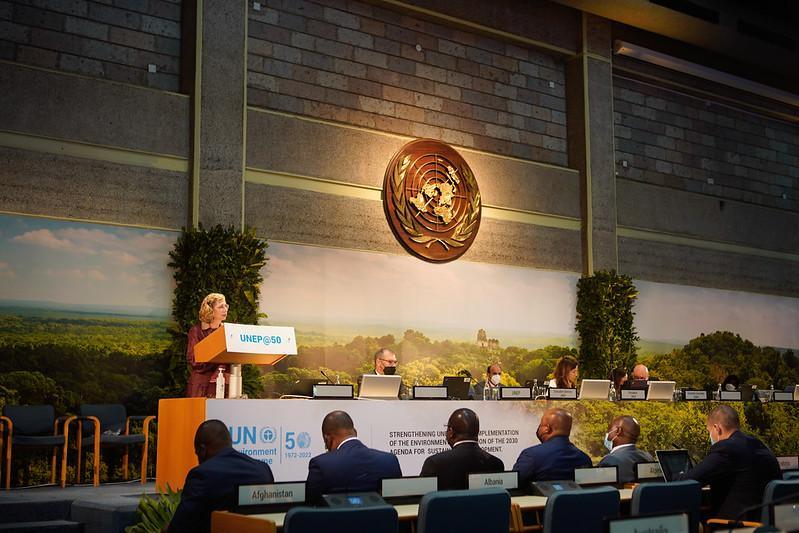 UNEA @ 50 plenary hall with the UN emblem and speakers on stage